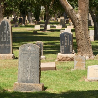 Tombstones sitting in a large field